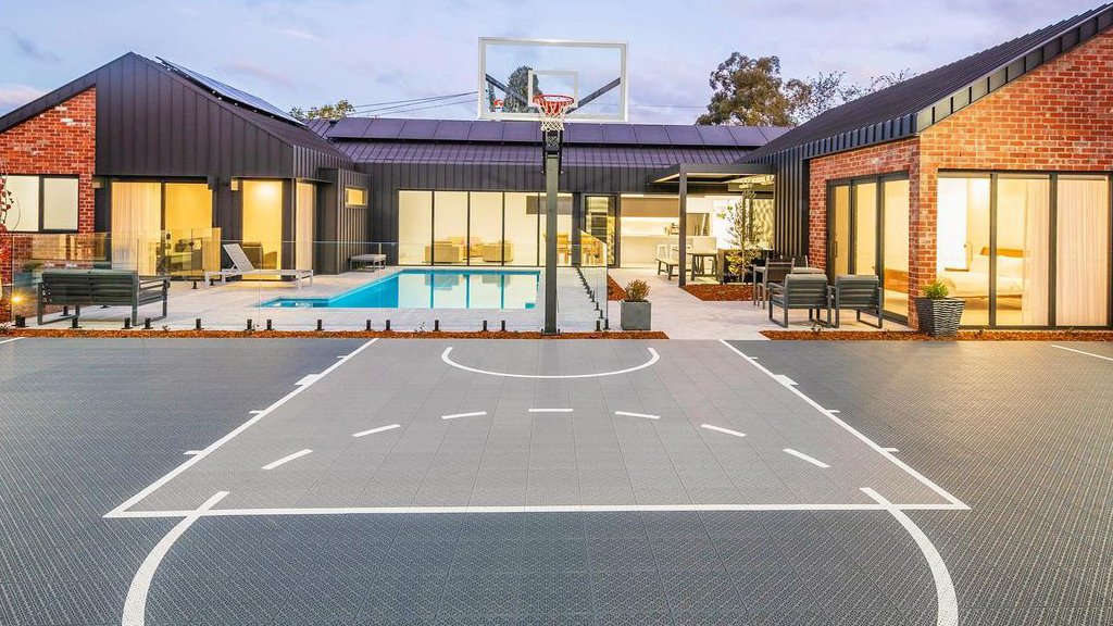 Gray modular basketball court in the same backyard setting
