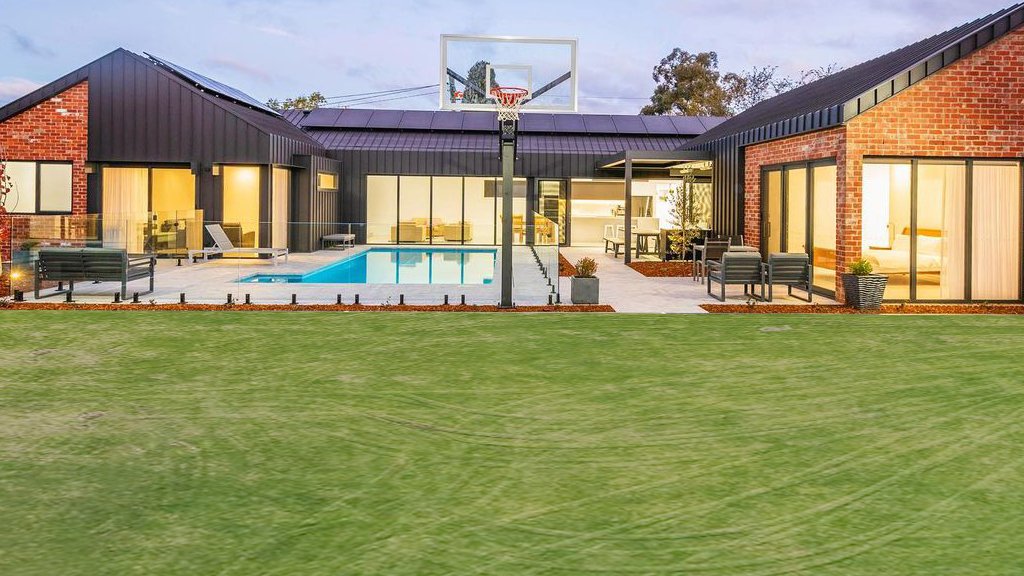 Backyard lawn before a modular sports court is added